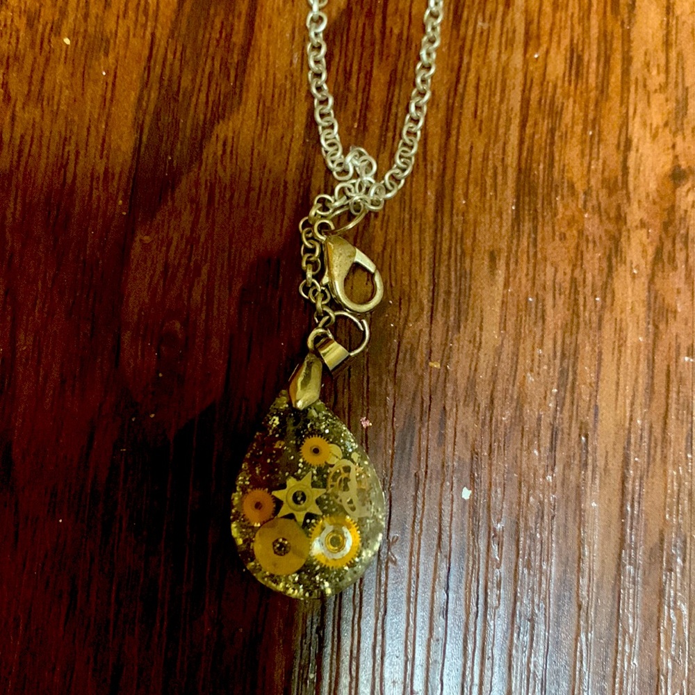 Stunning amber necklace piece with clock designs.